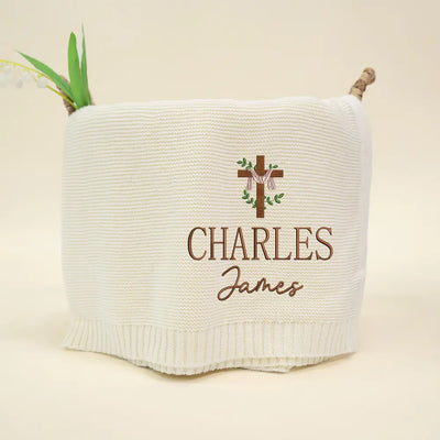 White woven basket with embroidered name 'Charles James' and cross design on a beige background