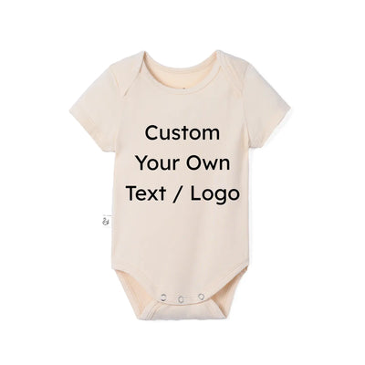 A light beige short-sleeve baby bodysuit with black text reading 'Custom Your Own Text / Logo' printed on the front, displayed on a clean white background.
