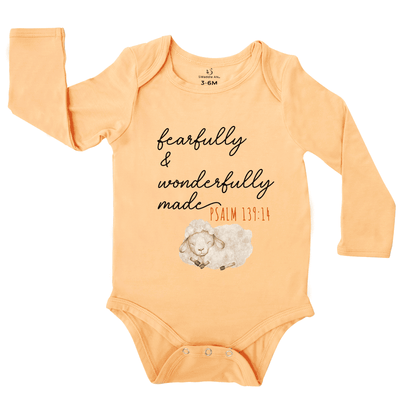 Orange baby onesie with text and sheep illustration on a white background