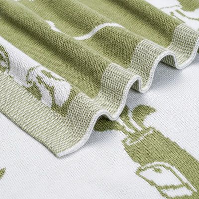 Golf baby blanket with Close-up of a green and white patterned fabric with golf illustrations.