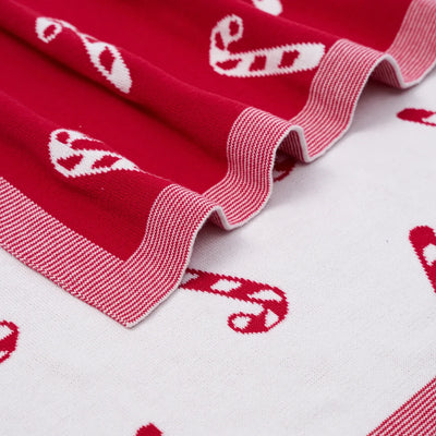 Red and white patterned fabric with candy cane design on a white background
