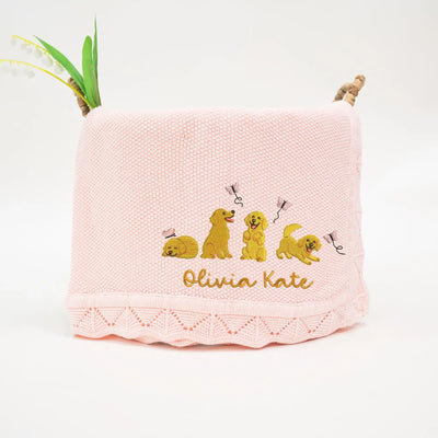 Pink personalized baby blanket with embroidered golden retrievers and 'Olivia Kate' text on a white background
