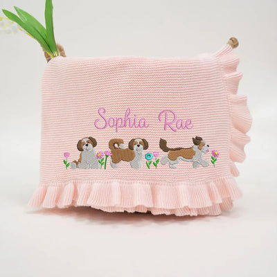 Pink personalized baby blanket with embroidered shih tzus and ruffled edge on a white background
