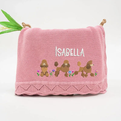 Rose pink personalized baby blanket with embroidered poodles and 'Isabella' text on a white background